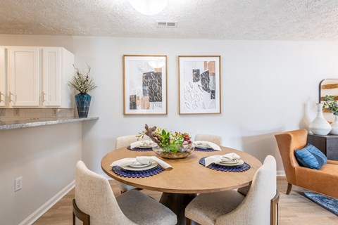 a dining room with a wooden table and chairs