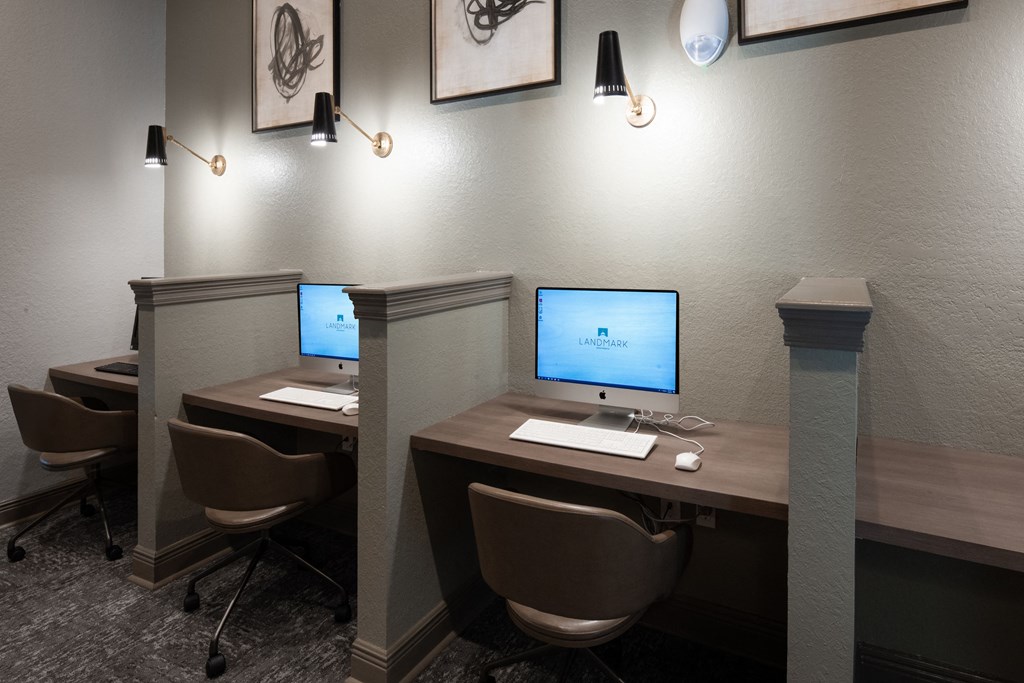 a conference room with two computer desks and chairs