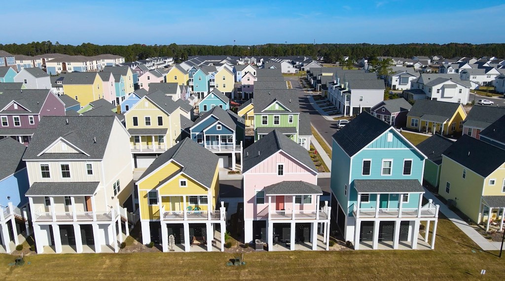 A row of colorful houses with white porches.