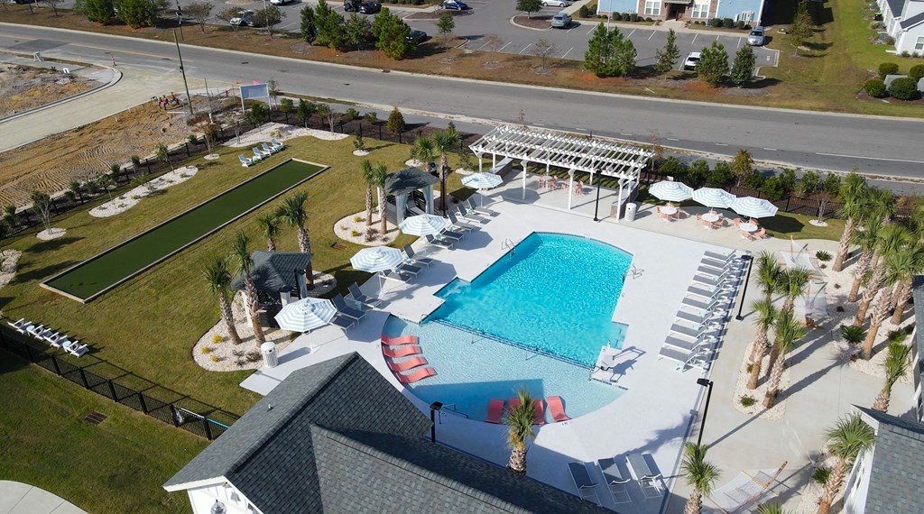 An aerial view of a pool and a building.