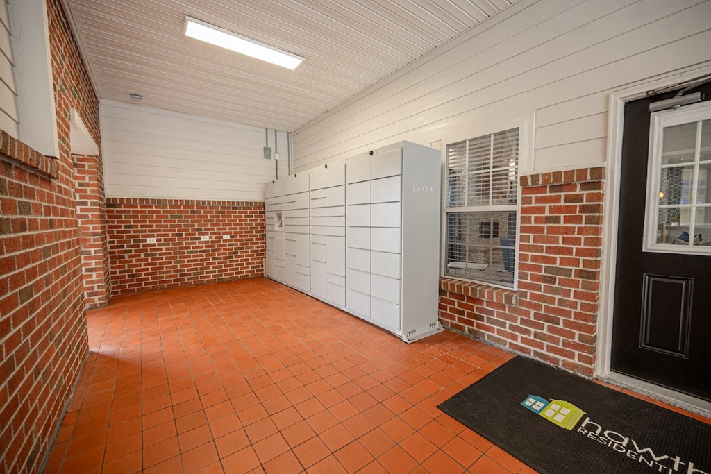 a storage room with a brick wall and a door