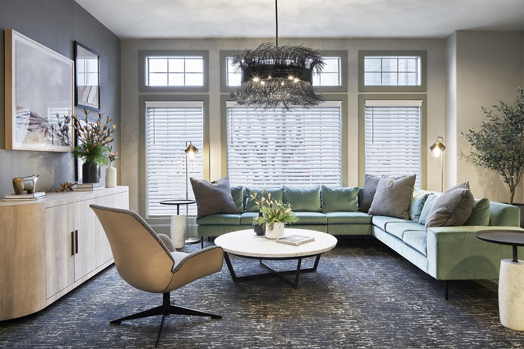 a living room with a green couch and a table