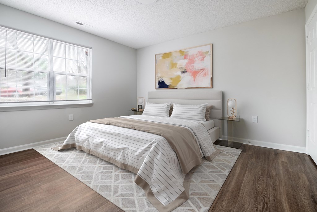 a bedroom with a bed and a window