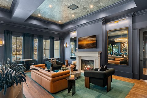 A living room with a fireplace and a painting on the wall.