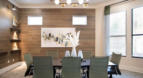 A seating area with a wooden wall and a large painting at Crossings at Pooler Apartments in Pooler, GA