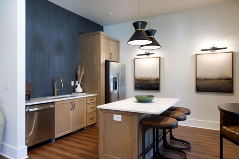 A kitchen with a white counter top and wooden cabinets.