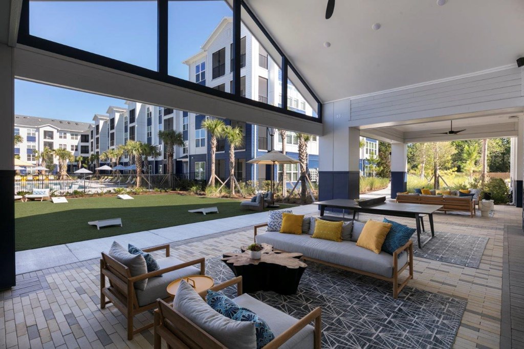 a living room with a view of a yard and buildings