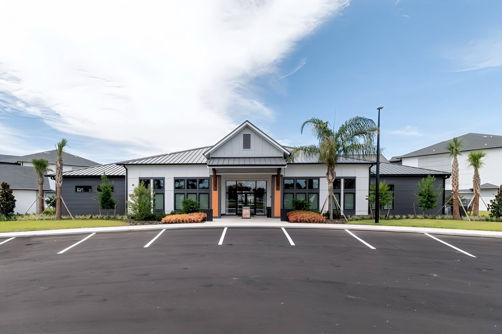 A building with a parking lot in front of it.
