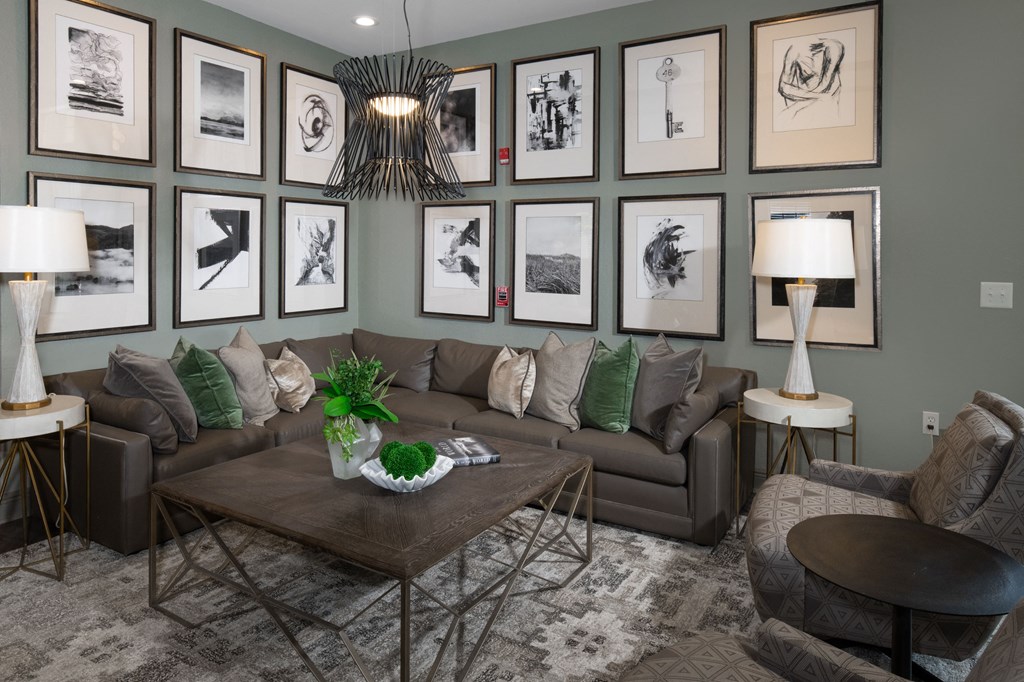 a living room with pictures on the wall and a brown couch