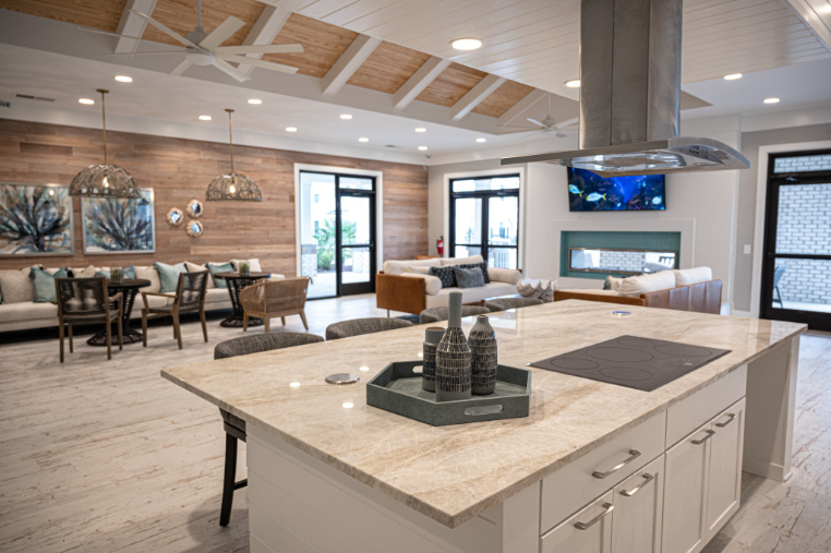 a kitchen with a large island and a living room with a fireplace