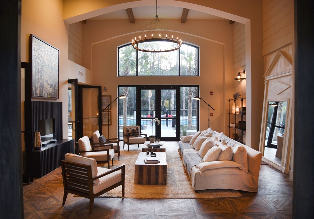 a large living room with a couch and chairs and a fireplace