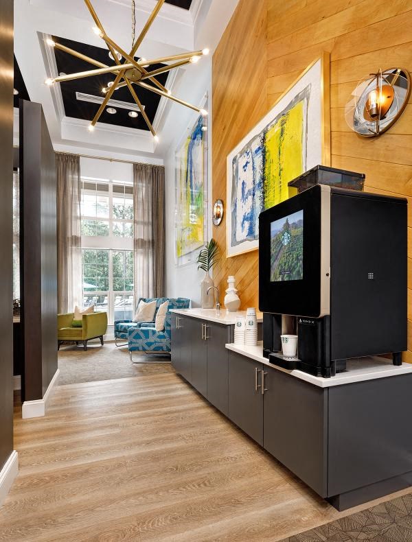 A modern kitchen with a black fridge and microwave.