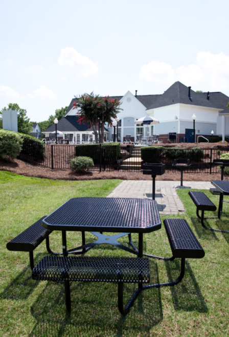 a picnic area with benches and tables in a park
