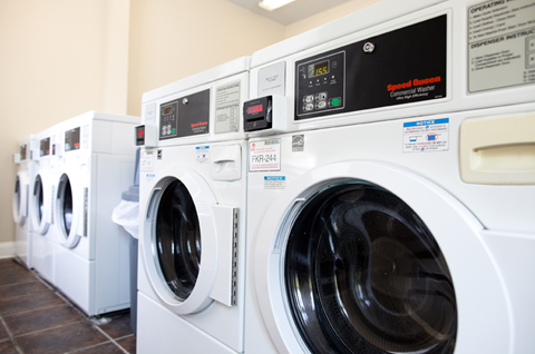 a row of washing machines in a laundry room