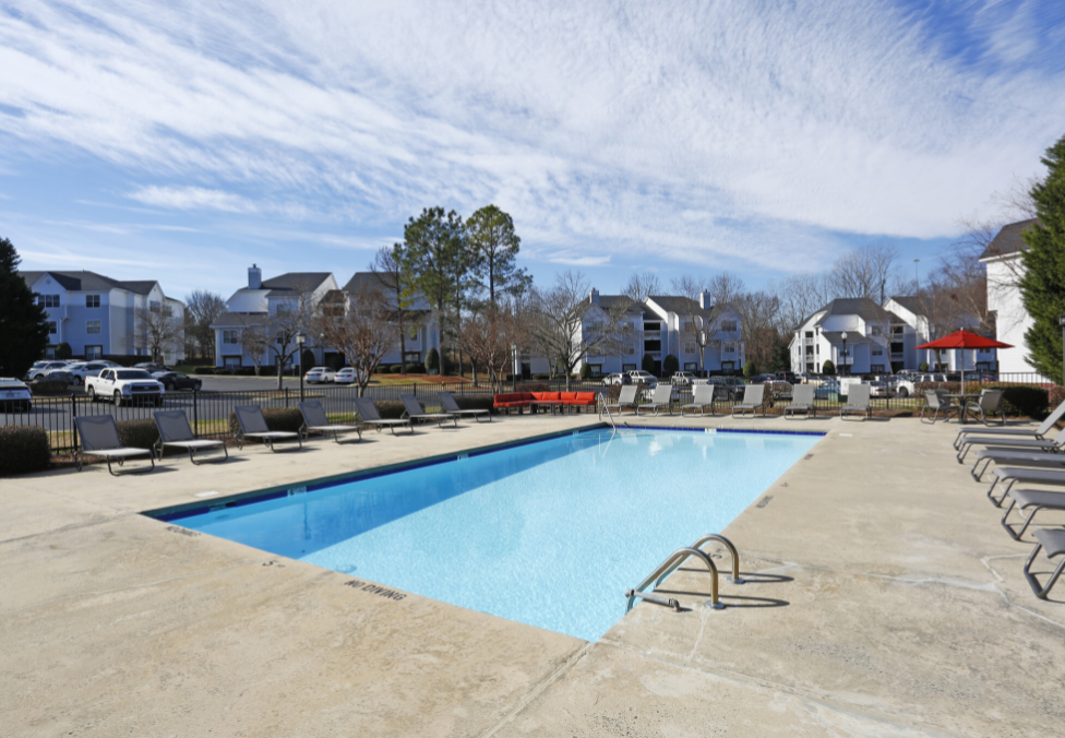 a swimming pool with rows of pool chairs