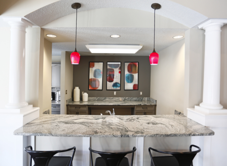 a view of a kitchen with a marble counter top and chairs