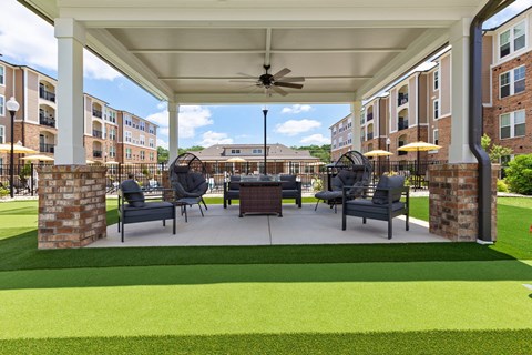 a rendering of a covered patio with a table and chairs