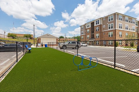 a fence with olympic rings in front of a building