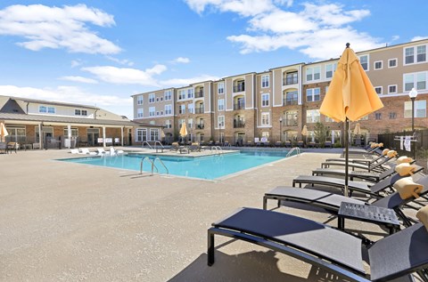 our apartments have a large pool with lounge chairs and umbrellas