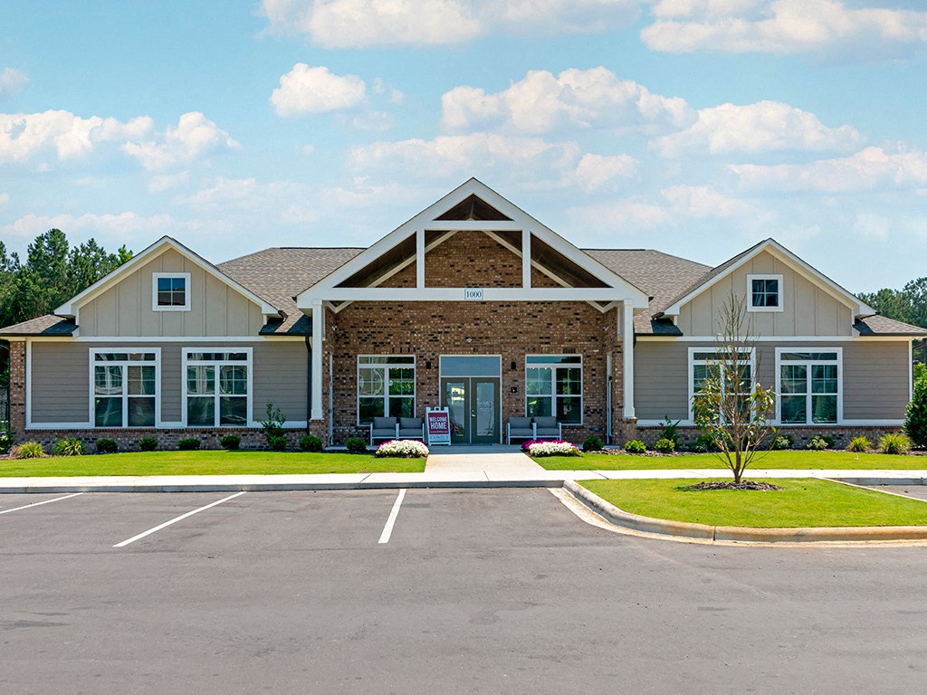 a large house with a parking lot in front of it