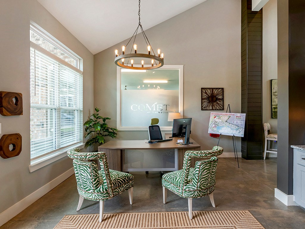 an office with two chairs and a desk with a computer