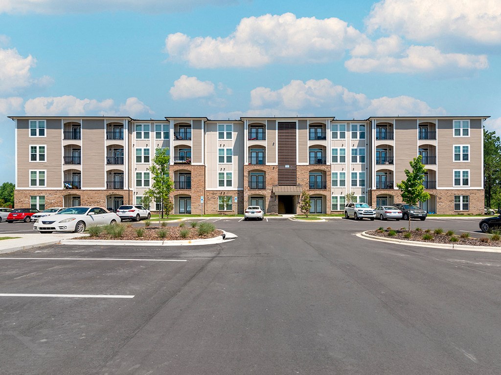 an empty parking lot in front of an apartment building