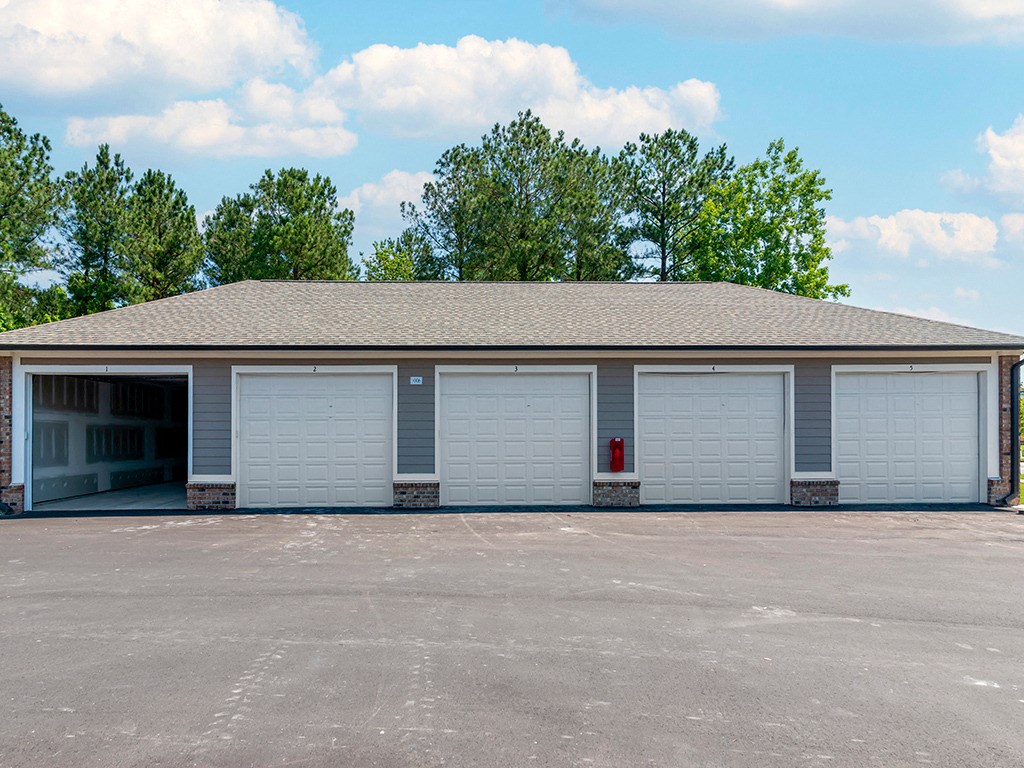 a garage with white doors and a parking lot