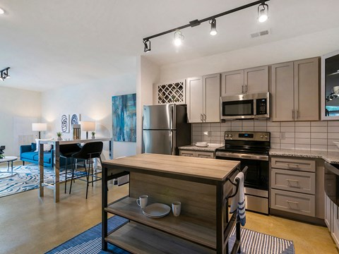 a kitchen with stainless steel appliances and a wooden island