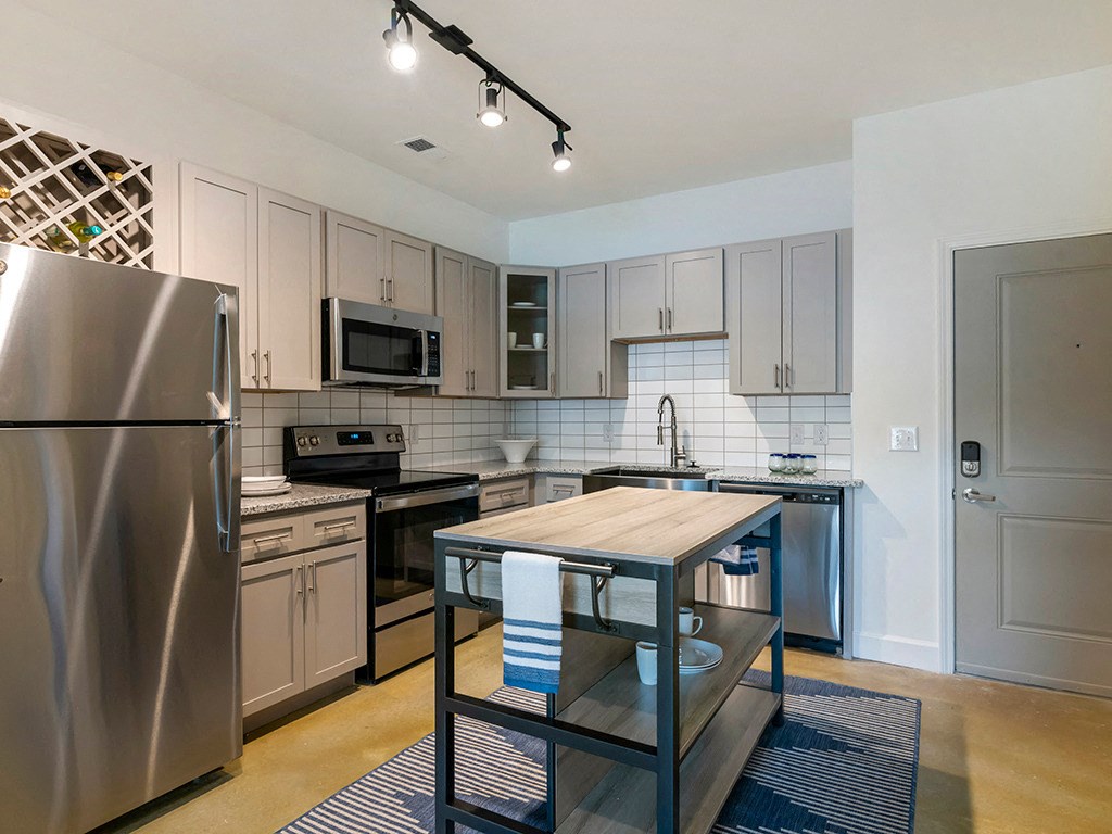 a kitchen with stainless steel appliances and a wooden table