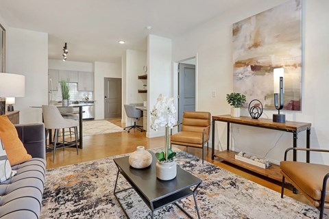 A modern living room with a grey sofa and a coffee table.