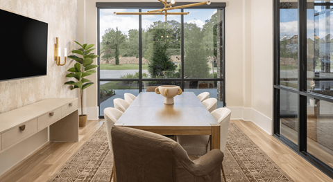 A conference room with a long table and chairs at Liam at Hays Farm in Huntsville, Alabama