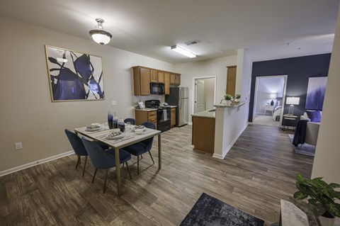 Dining, Kitchen and Living Room Area with Plank Wood Floors