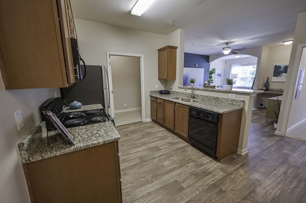 a kitchen with granite counter tops and wooden cabinets