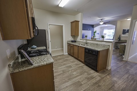 a kitchen with granite counter tops and wooden cabinets