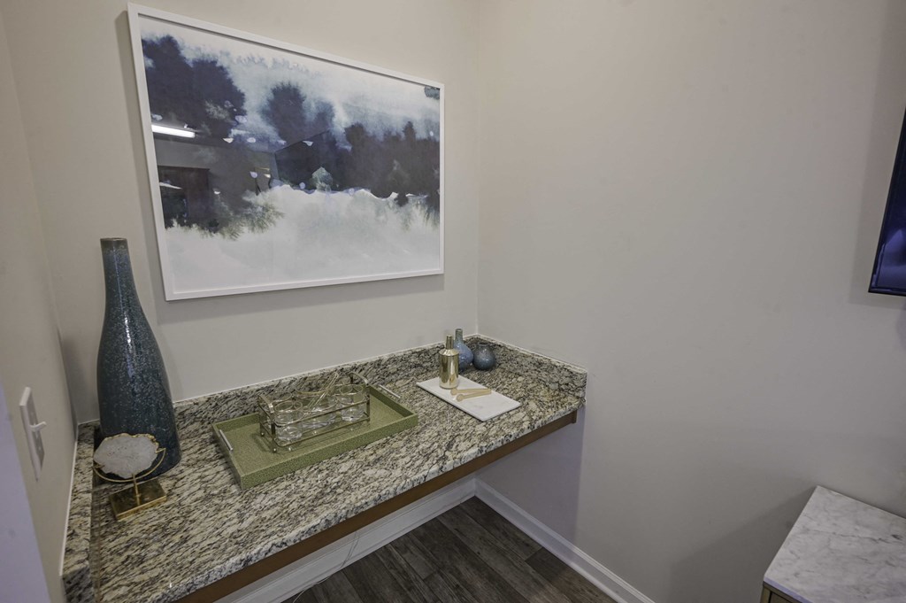 a vanity with a vase and a picture on the wall