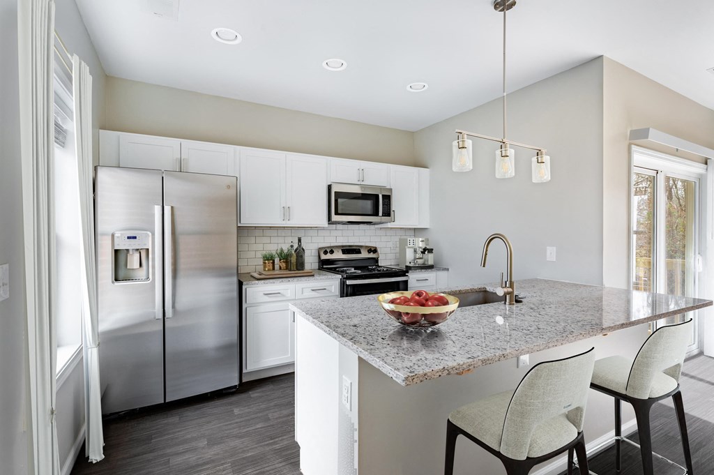 a kitchen with stainless steel appliances and a granite counter top