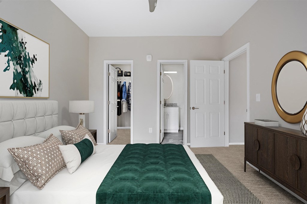 a bedroom with a white bed and a green blanket