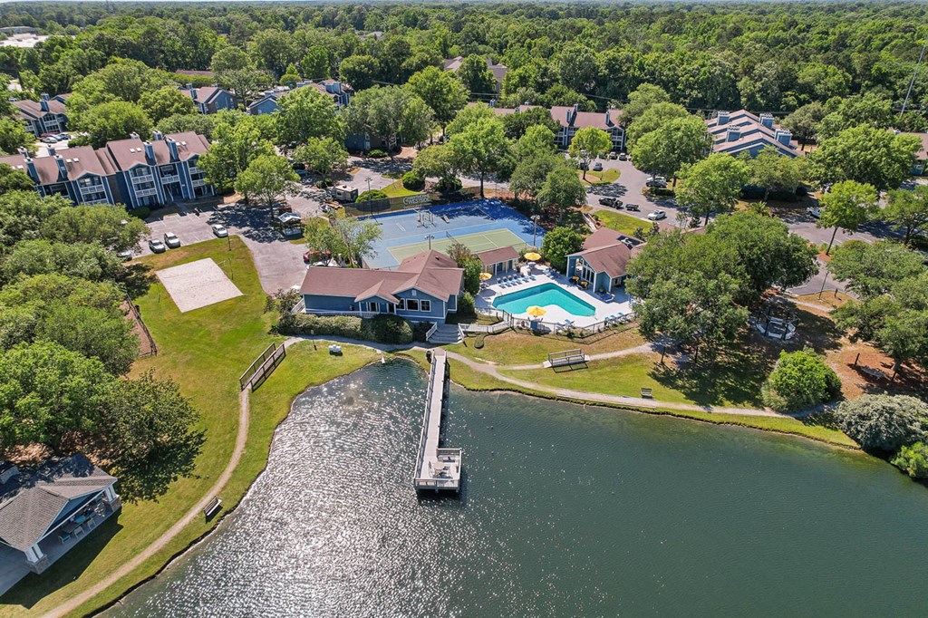 a view of a neighborhood with a body of water and a bridge