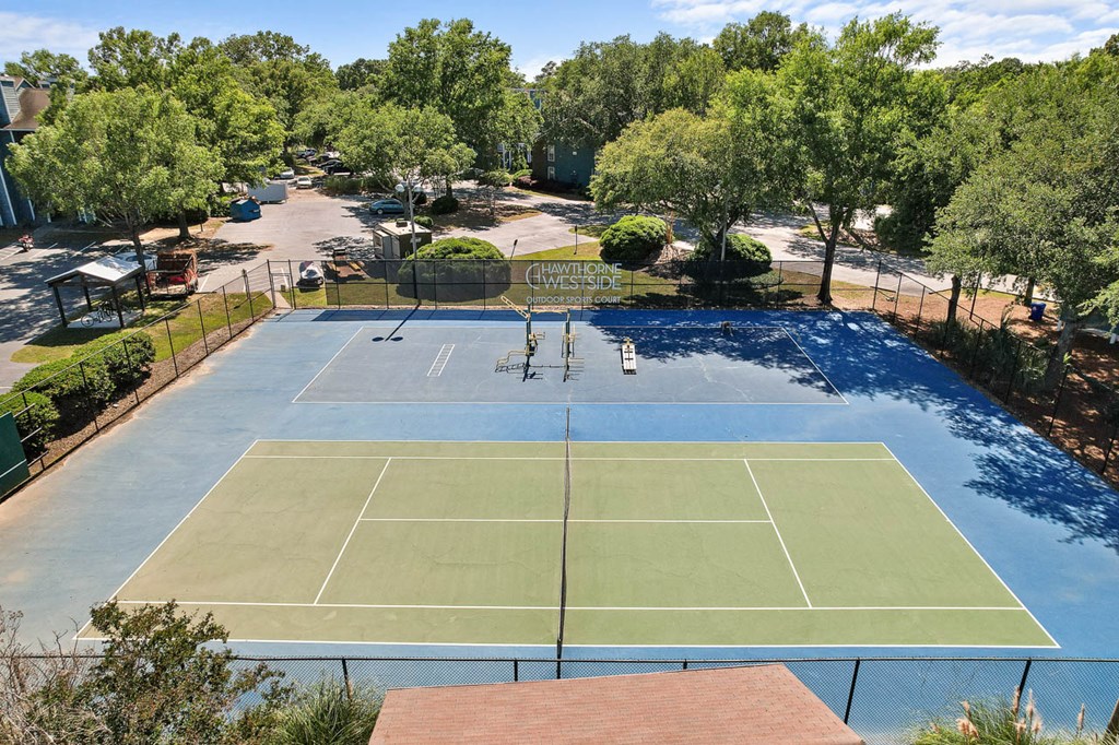 an aerial view of a tennis court and a pool