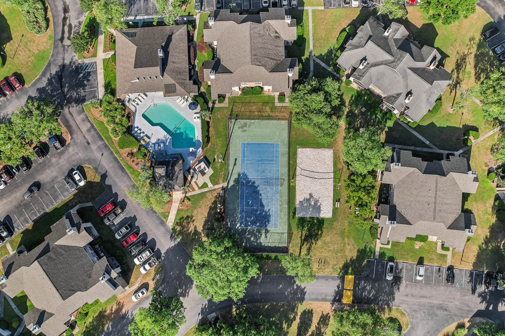 arial view of a house with a swimming pool in the middle of a neighborhood