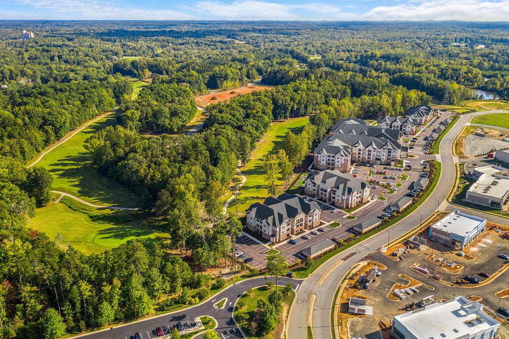 an aerial view of a city with houses and a highway