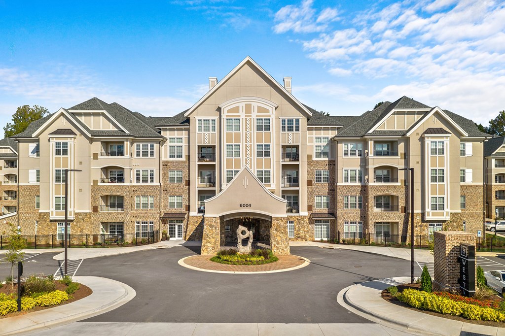 an exterior view of an apartment building with a fountain