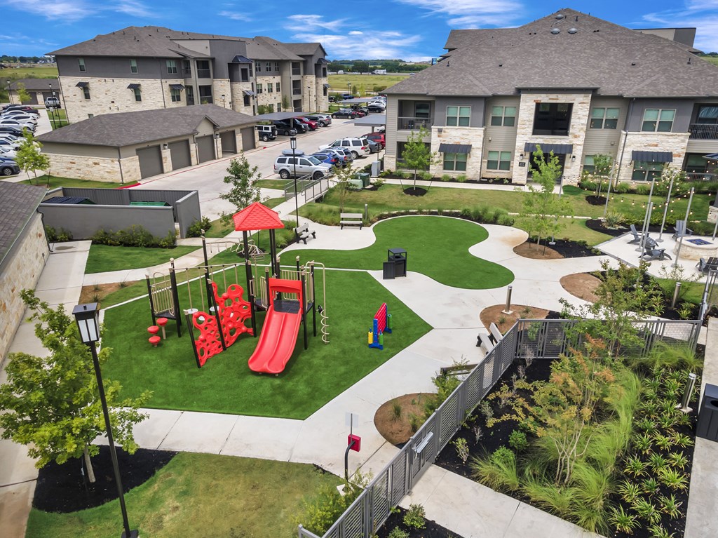 an aerial view of a playground in the middle of a community
