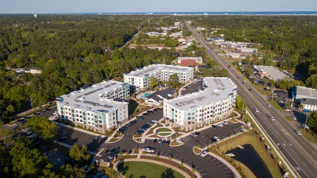 an aerial view of several apartment buildings and a highway
