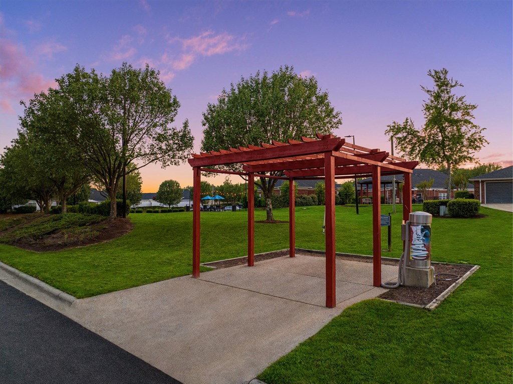 a park with a pavilion and a trash can