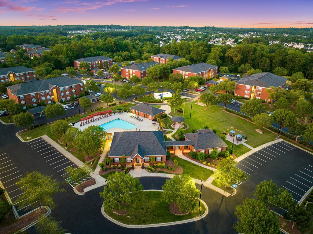 an aerial view of a neighborhood of houses and a pool
