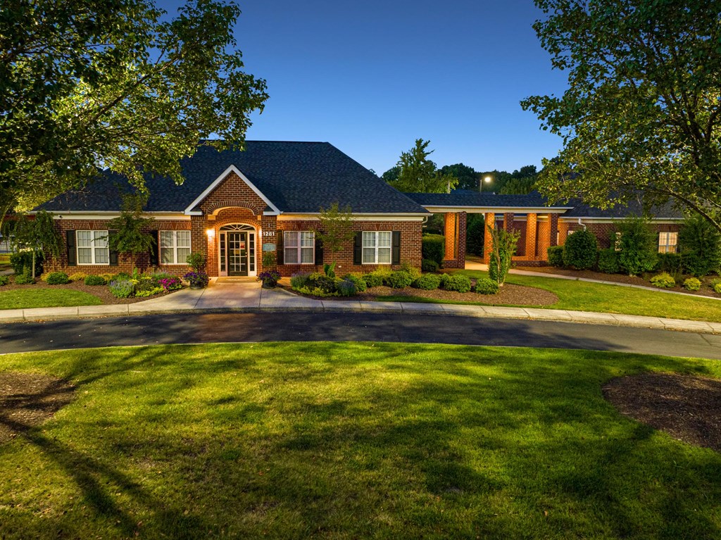 a painting of a house with a field of grass and trees