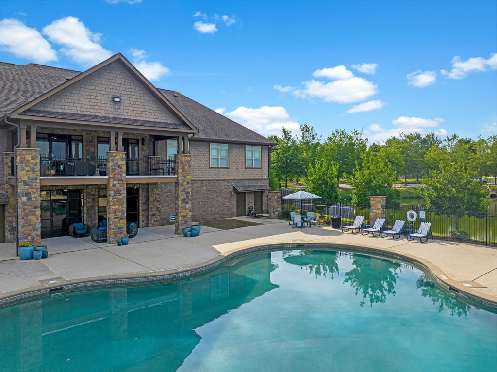 the backyard of a house with a swimming pool and patio