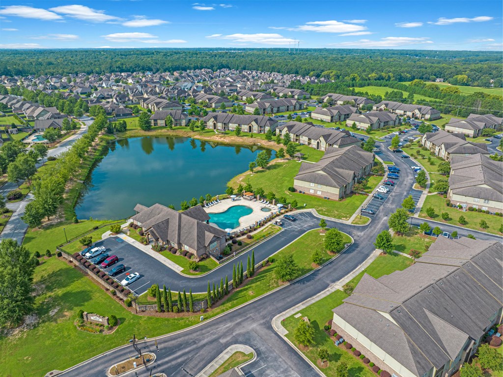 an aerial view of a community with a lake and houses