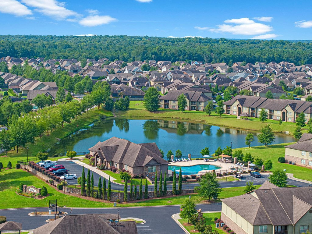 an aerial view of a community with a lake and houses
